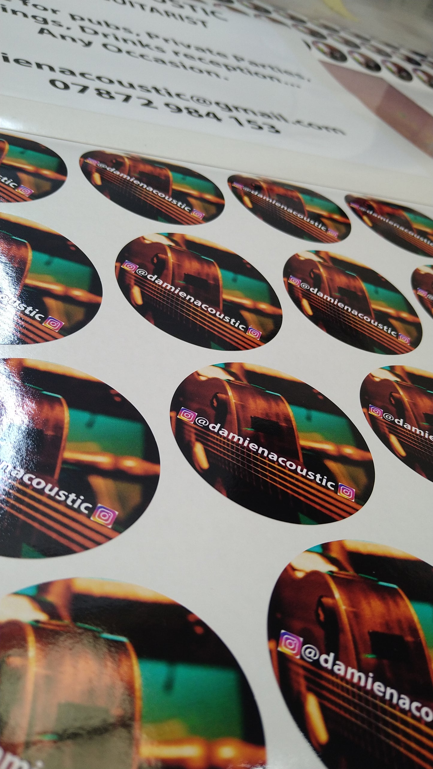 Stickers of a violin on a printed sheet with text and contact information.