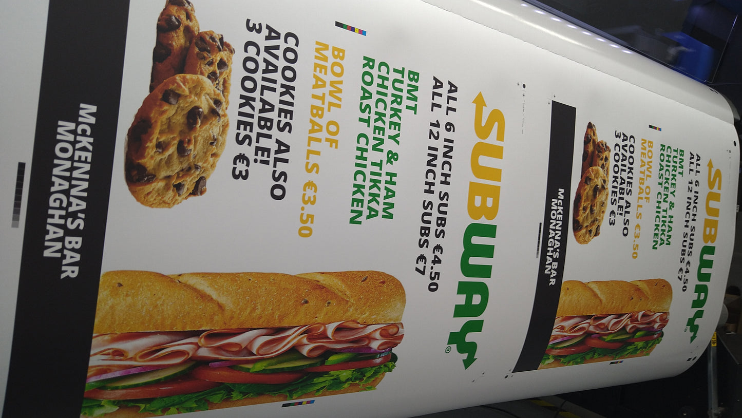 Subway menu board with sandwich and cookie images and text.