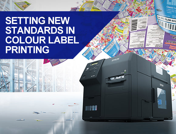 Label printing machine with colorful labels in the background and text 'Setting new standards in color label printing'.